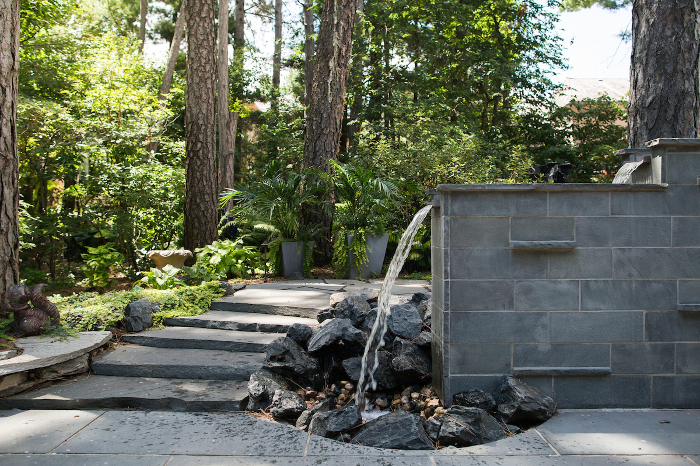 A stunning outdoor water feature set into a stone wall.