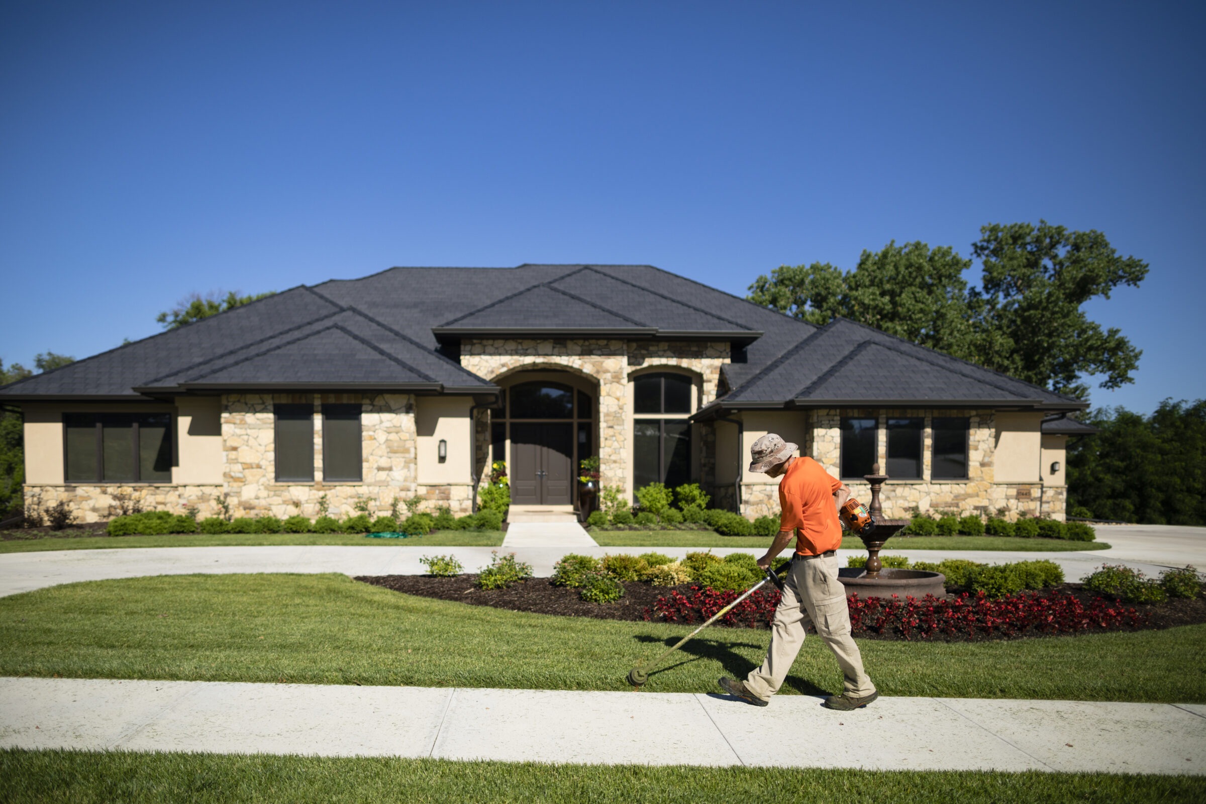 A Sun Valley team member helps to keep a lawn pest-free with routine maintenance.