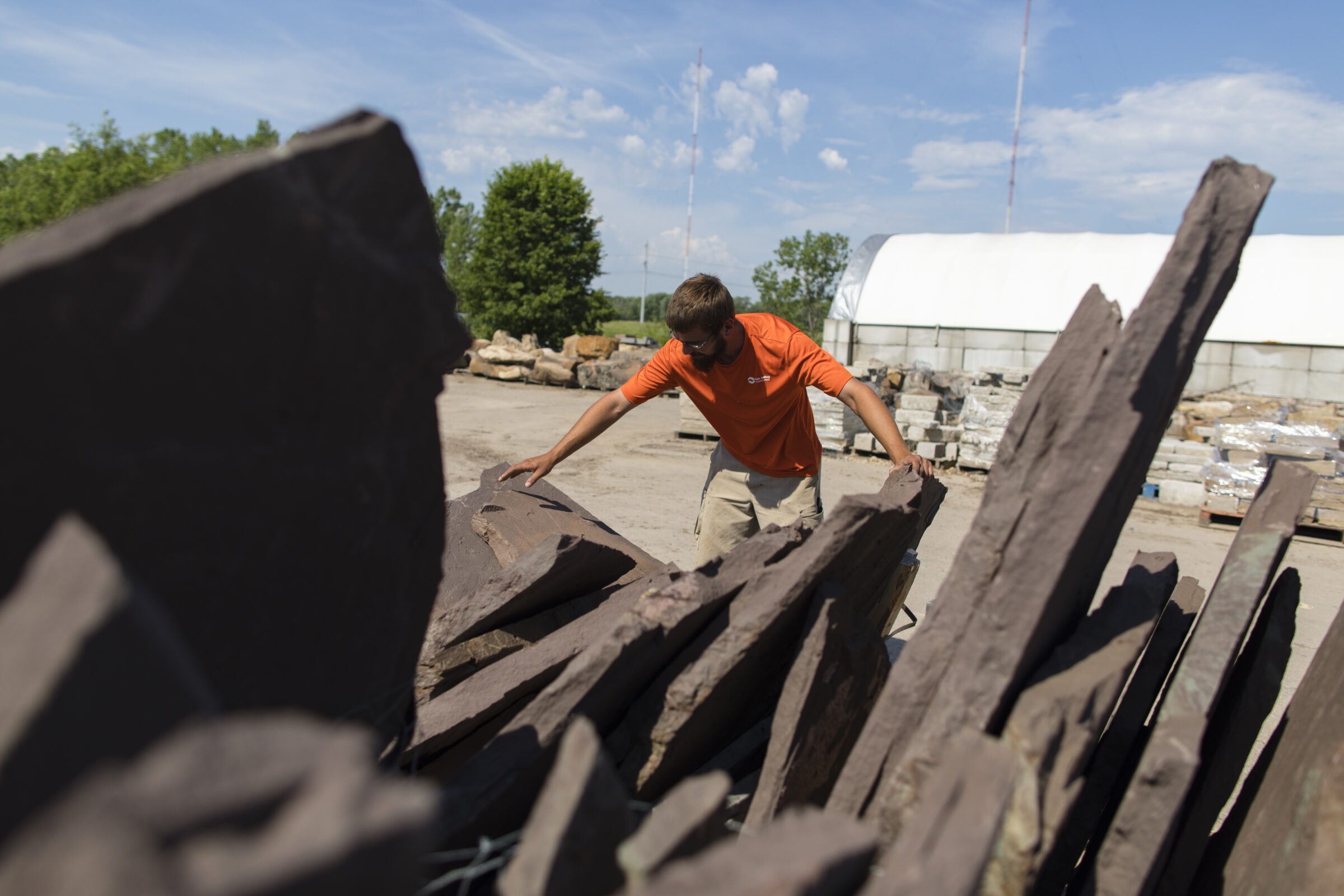 A Sun Valley team member preparing natural stone for a client's hardscaping project.