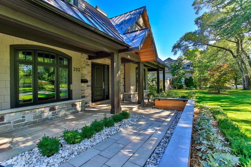 The front of a house with beautiful stone hardscaping.
