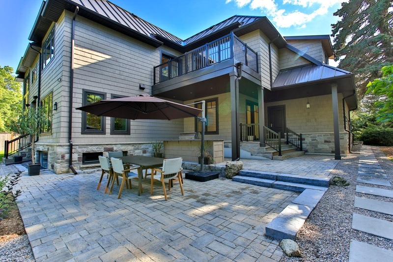 Hardscaping for a Sun Valley Landscaping client using a shade umbrella, a stone patio, and a built in outdoor kitchen.